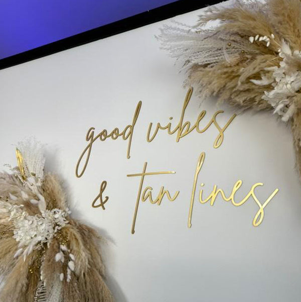 gold metallic wall logo sign designed by Signature Synes for tanning studio UK